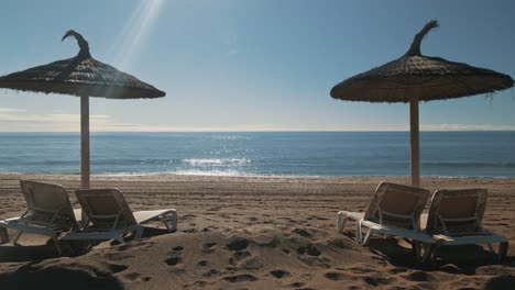 Sunny-beach-loop-with-parasol-and-chairs