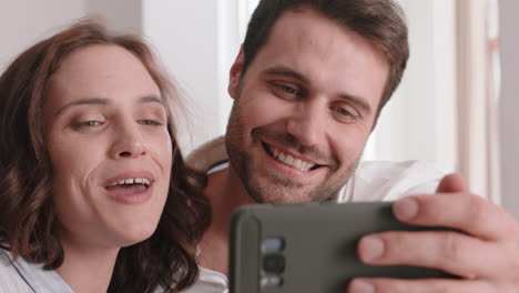 happy couple having video chat using smartphone chatting to friend smiling excited enjoying online communication on mobile phone