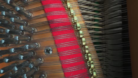 close-up detail of hammers striking the strings inside an upright piano. abstract view of the intricate inner mechanism of a classical musical instrument