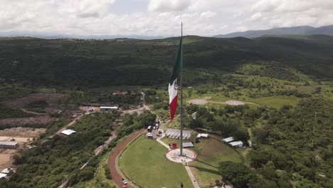 aerial orbit view around mexican flag for independence declaration in iguala