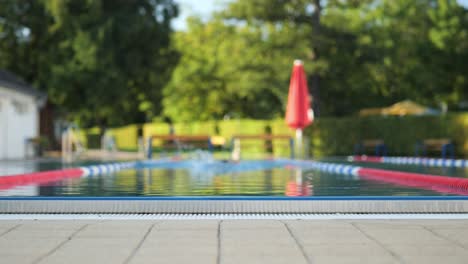 male swimmer swims towards the camera from the blur into the focus medium shot