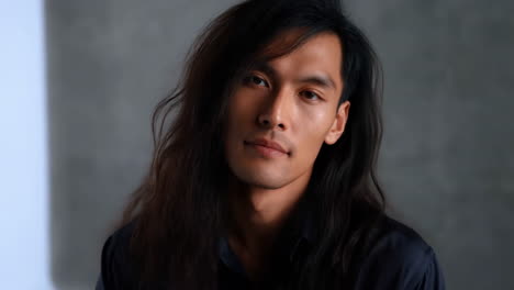 portrait of a man with long dark hair