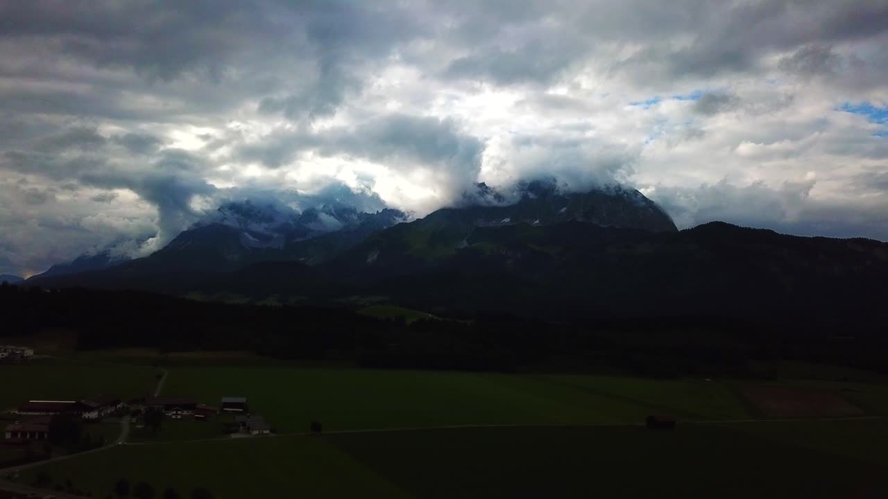Drone view of a stormy cloudscape above a mountain valley, Oberndorf, Austria