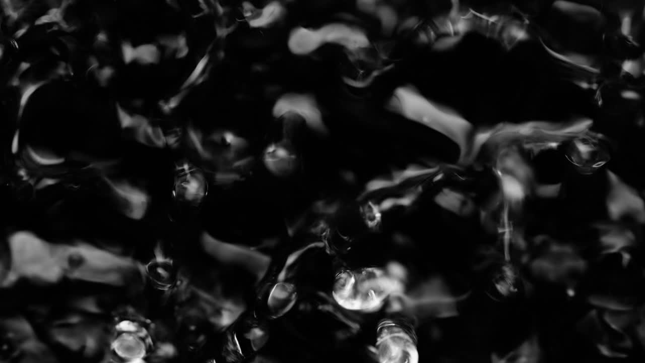 액체의 표면에 스플래시와 물방울, 추상적인 검은 배경 물 진동, 4k 느린 동작, 100fps, 42bits, 10bits