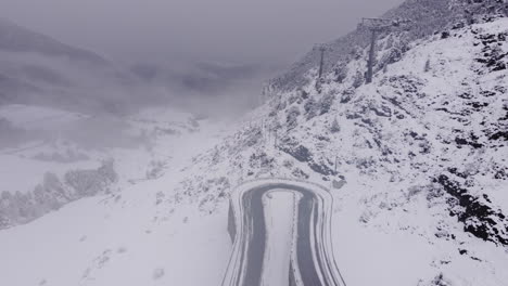 freezing weather conditions on a mountain road, heavy snow, icy fog, no people