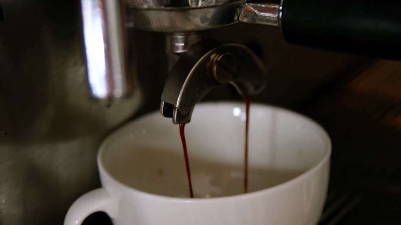 Waiter making cup of coffee