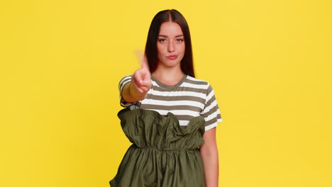 Woman angrily waving finger shaking head expressing dissatisfaction disapproval angry reaction