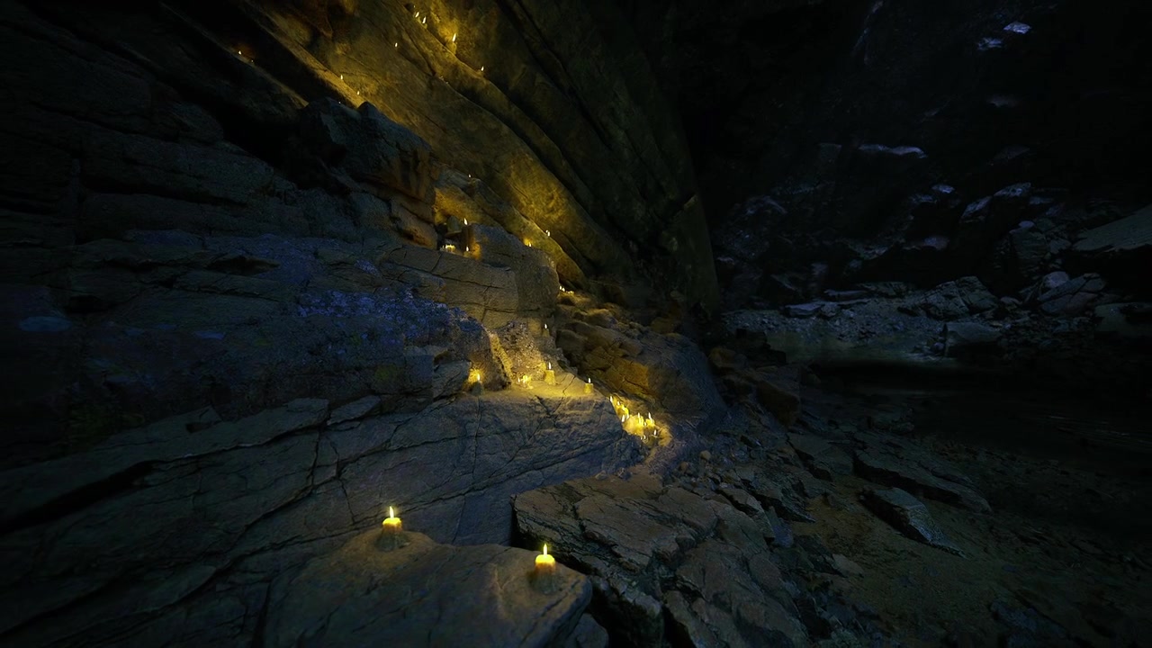 Luminescent candles line rugged cavern path for respectful procession