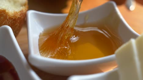 close up of honey dripping onto a spoon