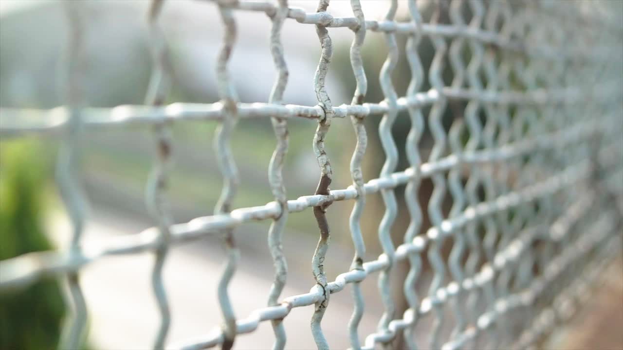 moving shot, road safety wire fence with background blur