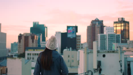 Girl,-city-and-buildings-with-sunset-in-sky