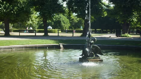 fountain of a boy fighting a swan in kongens have in copenhagen, denmark