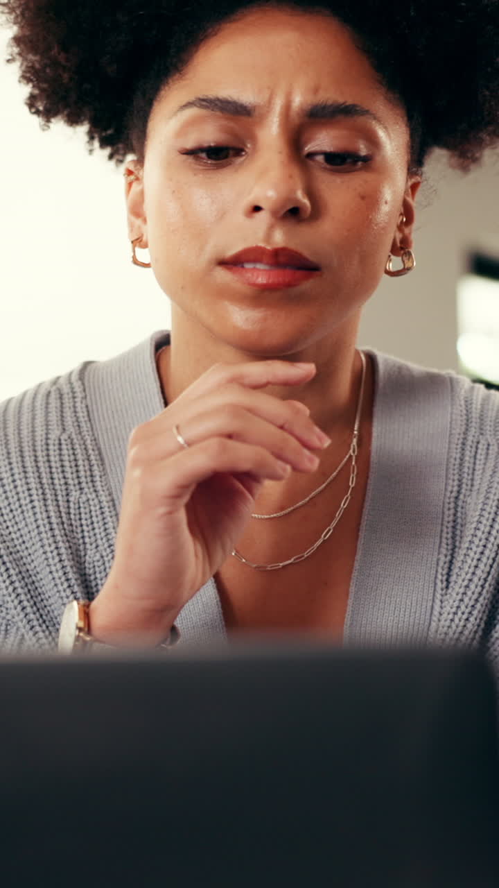 Focused Woman Thinking While Working on Laptop