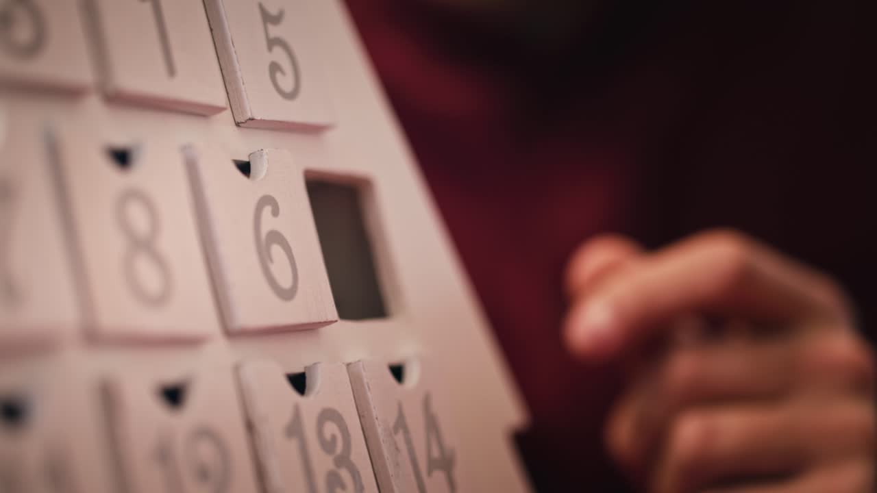 Handheld view of child and advent calendar