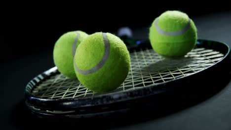 tennis balls and racket in studio 4k