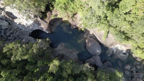 Creek-Surrounded-With-Rugged-Rocks-And-Green-Woodland-In-Babinda-Boulders-In-Cairns,-Far-North-Queensland,-Australia---aerial-top-down,-orbit