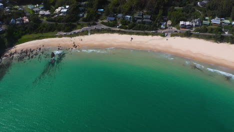 boat beach on seal rocks new south wales coastline, australia, aerial reveal