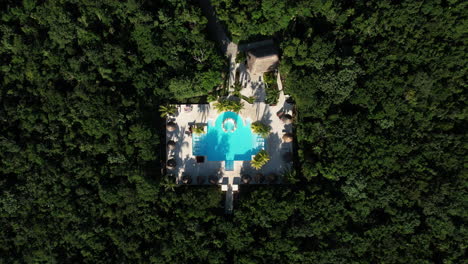 top down aerial view of private villa with swimming pool in tropical rainforest