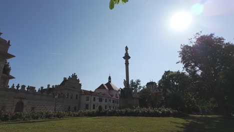 sunny day at marian plague column in prague with historic architecture and clear blue sky