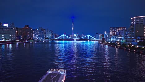 Night-light-Tokyo,-Tsukuda,-Toyosu-skyscrapers-and-Kiyosu-bridge-The-Sumida-River-Yakatabune,-pleasure-boat