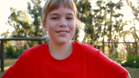 happy girl standing with hands on hip in boot camp