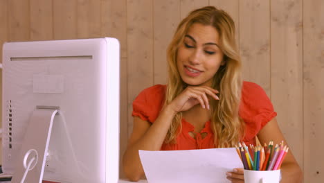 Pretty-worker-using-video-chat-at-desk