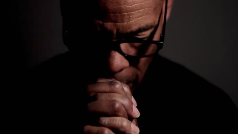 man praying to god with hands together on grey background stock footage