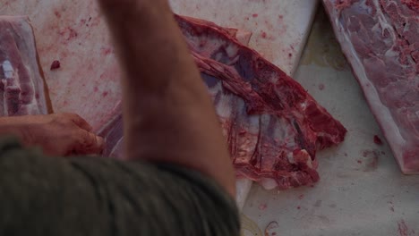 cutting pork ribs by hand during traditional slaughter in minho northern portugal