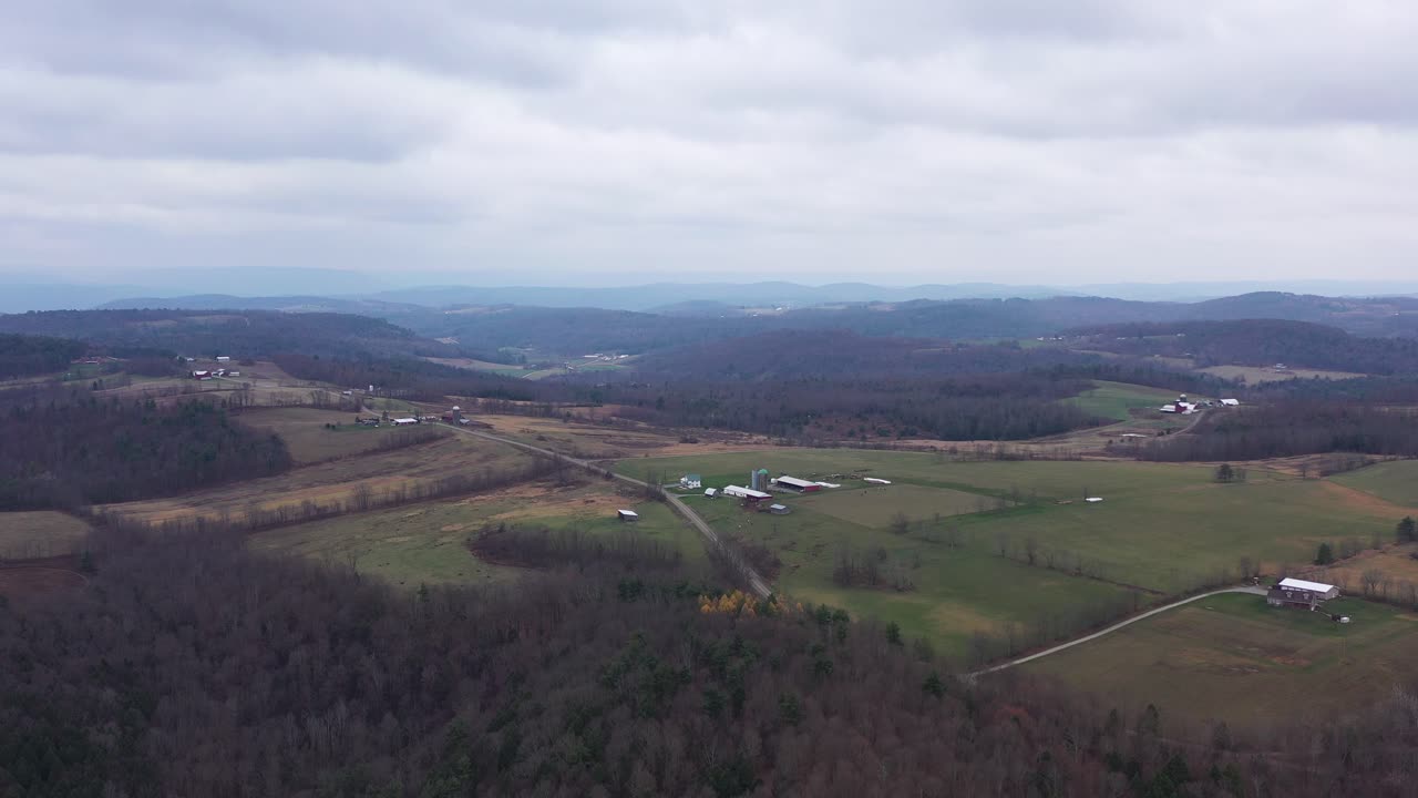 Aerial view of a wooded rural area with white clouds in the sky, agricultural farms, panoramic views of the countryside in Rome, Bradford County, Pennsylvania, Panoramic Aerial View