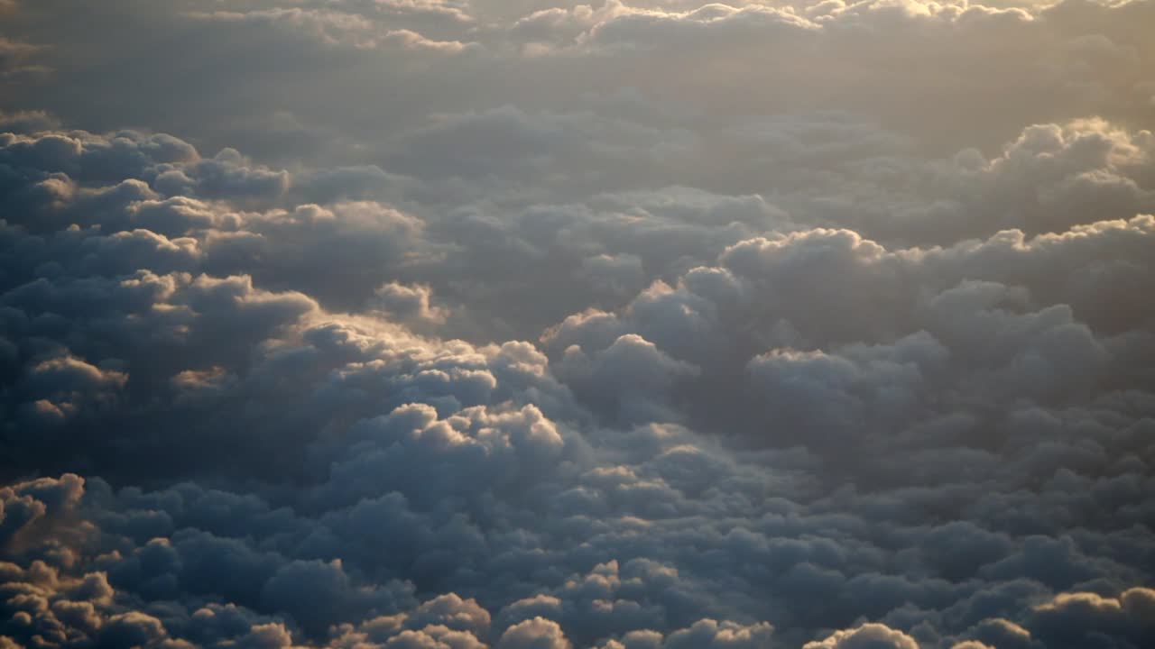 A high-altitude view of a dense cloud cover at sunrise or sunset.
