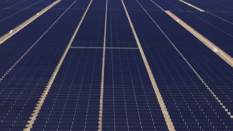 wide view of an expansive solar panel field stretching across a sunny landscape