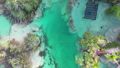 Birds-Eye-Aerial-View-of-People-Enjoying-in-Tropical-Water,-Bacalar-Lagoon-Lake-Region,-Mexico