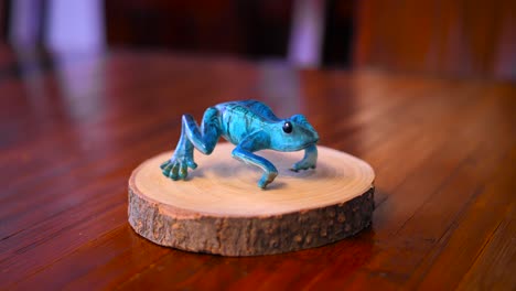 Blue-Frog-Carved-From-Wood-Standing-On-A-Wooden-Presentation-Base