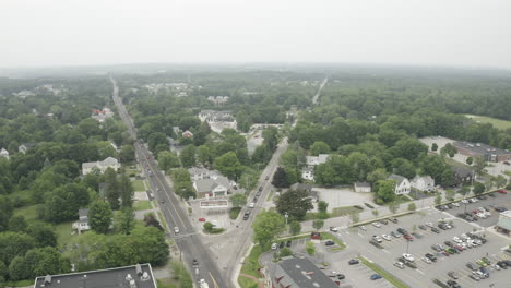 aerial fly over drone footage over intersecting road in gorham downtown, cumberland county in maine, usa