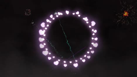 Animation-of-circle-of-heart-fairy-lights-with-christmas-and-new-year-fireworks-in-night-sky