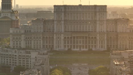 exterior view of palace of the parliament atop dealul spirii with national cathedral during sunset in bucharest, romania. - aerial