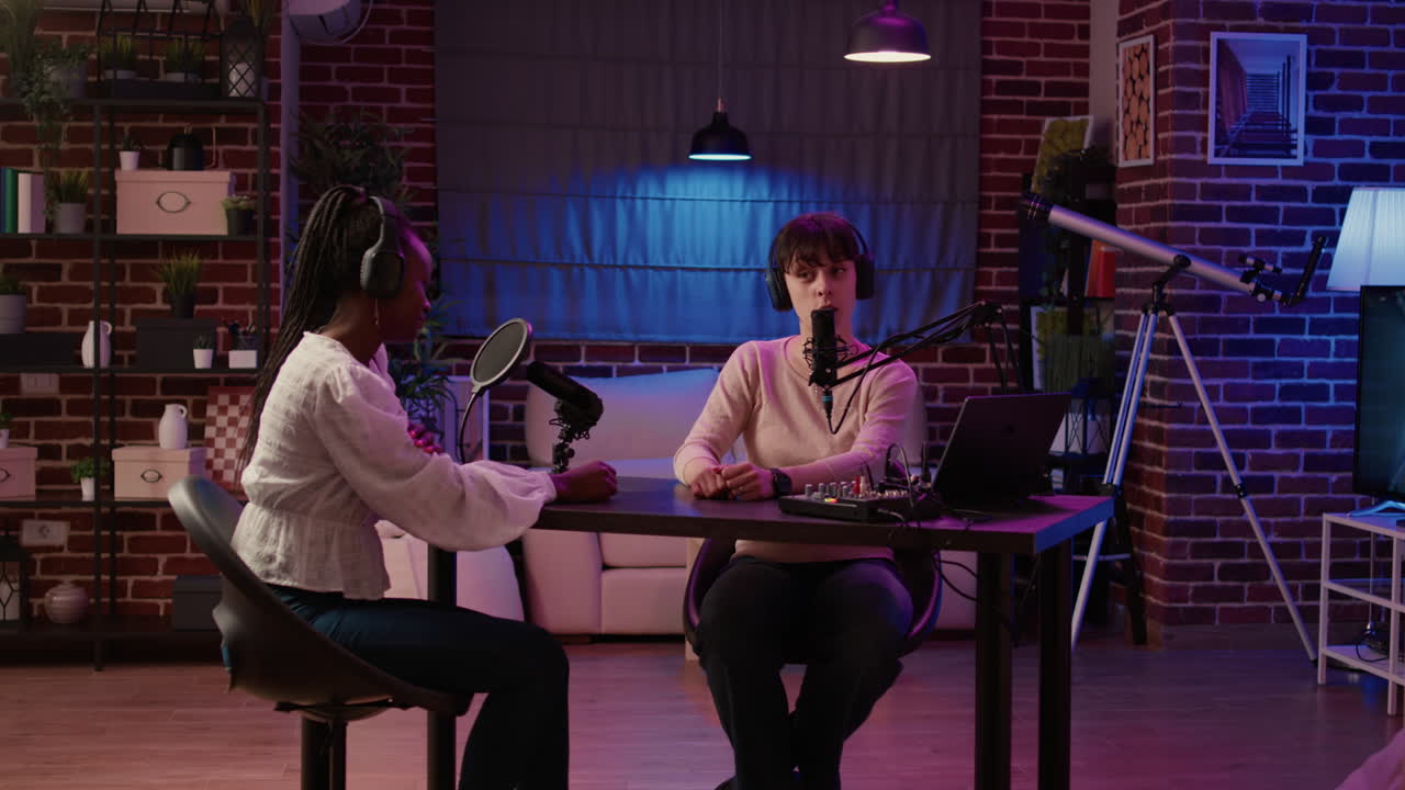 Online radio host having casual interview with african american singer in late night entertainment show