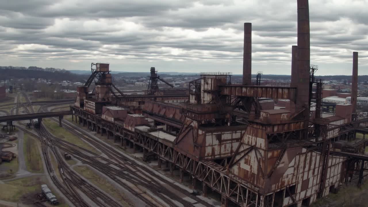 Aerial view of an industrial complex showcasing rusted structures and smokestacks, capturing the essence of a bygone era in manufacturing and heavy industry