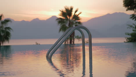 A-closeup-of-an-open-swimming-pool-railing-against-the-evening-scenery