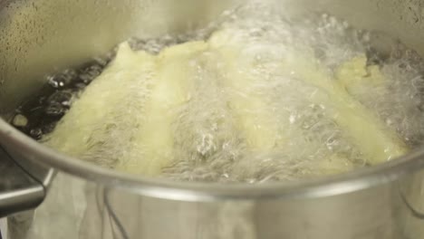 close shot of white cauliflowers being boiled in a pot of water