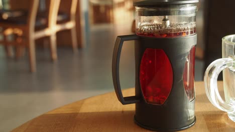 glass teapot on wooden table
