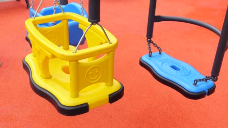 yellow and blue swings on a playground