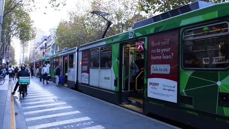 passengers disembark tram at melbourne street stop