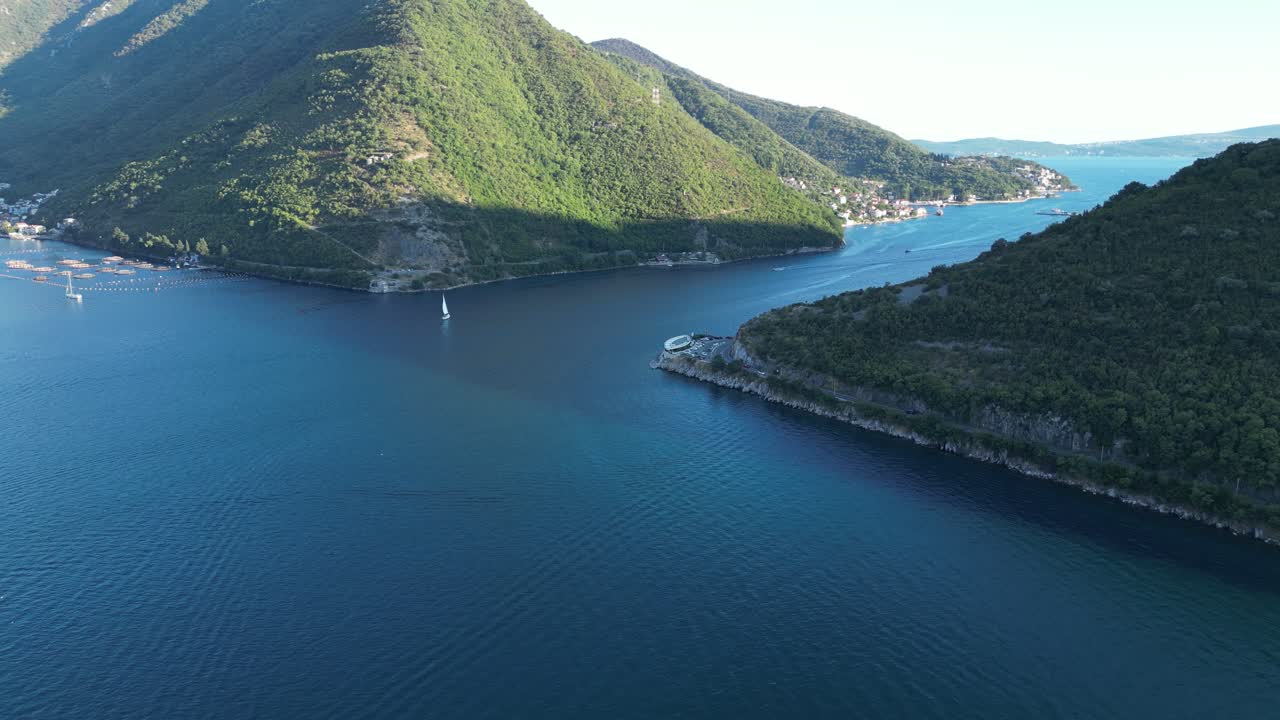 A slender blue passageway guiding the way to a secluded haven nestled among high peaks