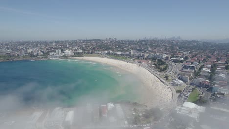 Fog-Rare-Event-Phenomenon-At-Bondi-Beach-In-NSW,-Australia---aerial-pullback