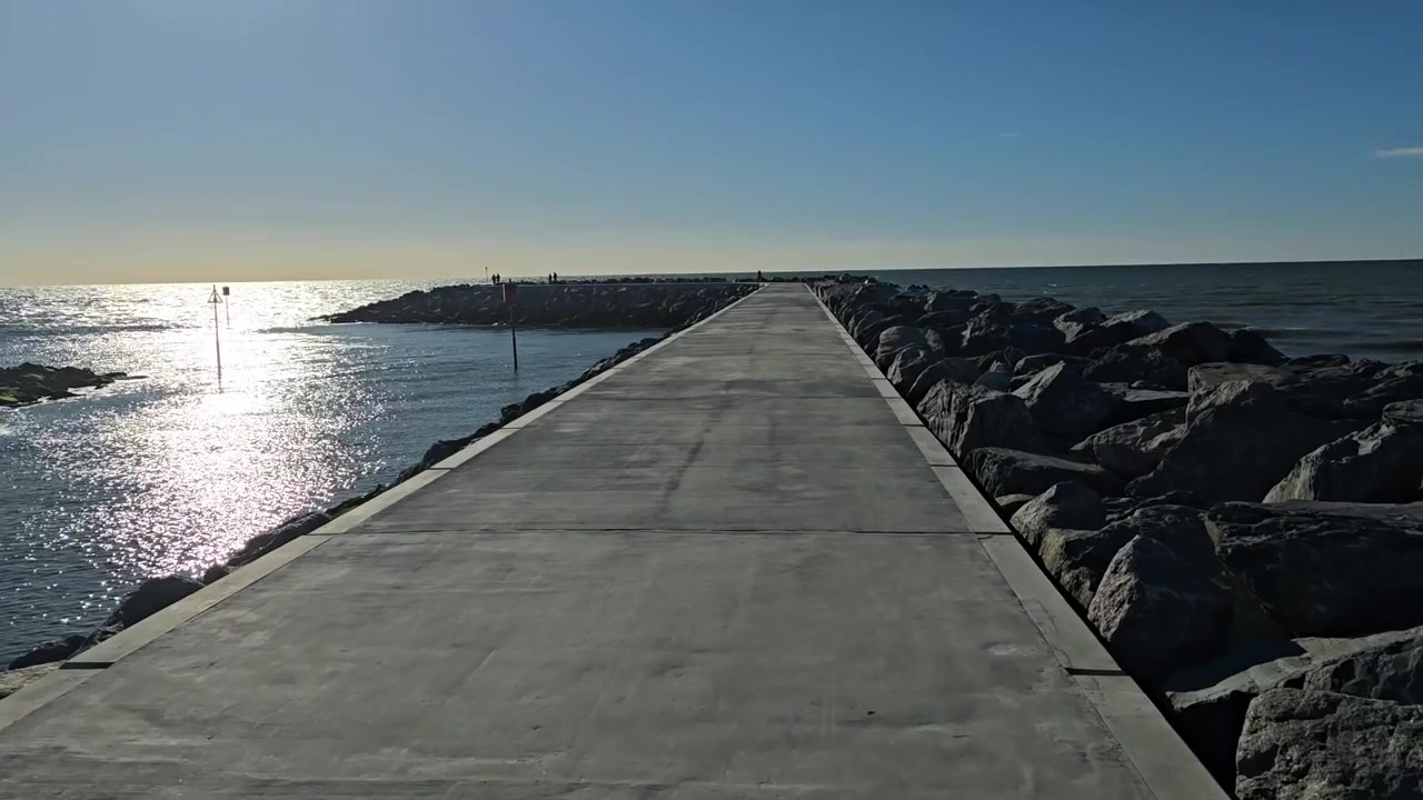 Muro del puerto de Aberaeron, rompeolas y puerto exterior, Bahía de Cardigan, oeste de Gales, en un día soleado de verano, caminando por el nuevo rompeolas.