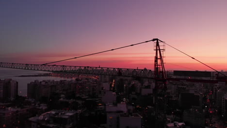 construction crane in the city at sunset pedestal shot