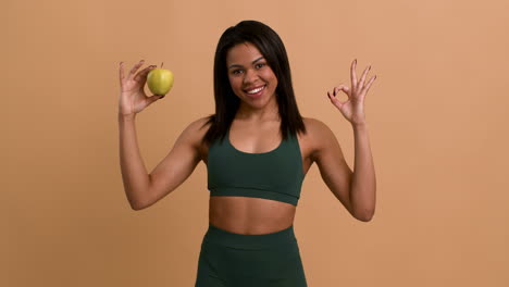 woman in sportswear with an apple