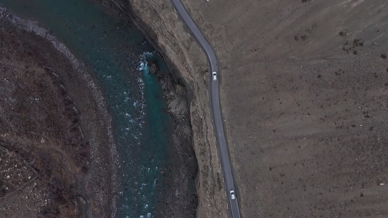 Aerial View of a River and Road through a Mountain Valley