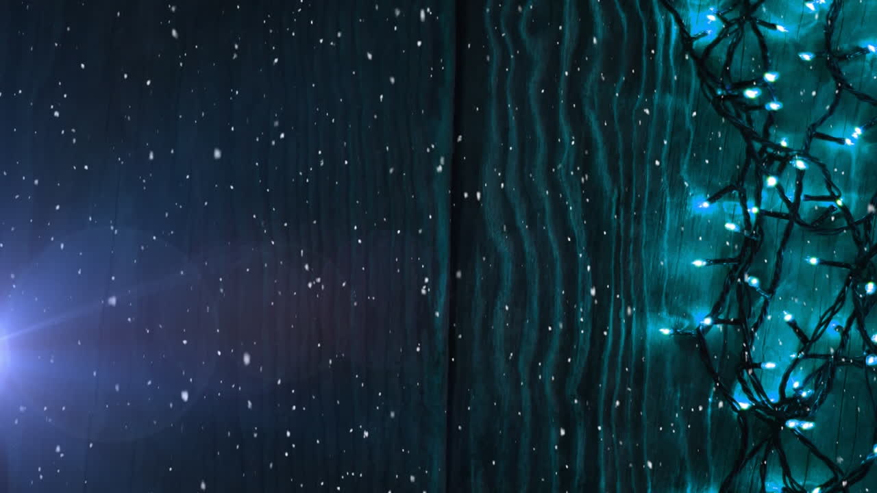 Animation of snow falling by tree with fairy lights